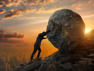 business man pushing large stone up to hill business heavy tasks and problems concept