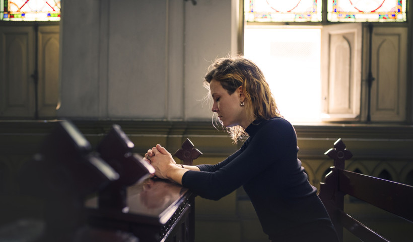 woman praying church